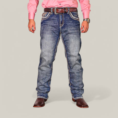 A person in a pink long-sleeve shirt and Western Blue Straight Fit Embroidered Jeans WJ-2348 stands against a plain background. Paired with a brown belt and cowboy boots, the flattering fit emphasizes their stylish ensemble.