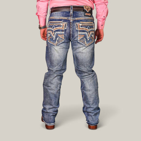 Rear view of a person wearing a pink long-sleeve shirt, brown leather boots, and Western Blue Straight Fit Embroidered Jeans WJ-2348 with embroidered back pockets, textured pattern, and a waistband leather patch for a flattering fit.