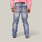 A person wearing a pink shirt, Western Blue Straight Fit Embroidered Jeans WJ-2347, a studded belt, and brown cowboy boots stands with their back to the camera against a plain background.