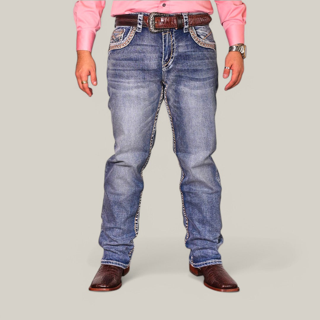 A person is against a light gray background, wearing a pink shirt and Western Blue Straight Fit Embroidered Jeans WJ-2349. They have brown cowboy boots, a matching belt, and a wristwatch, with their hands relaxed at their sides.