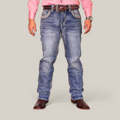 A person is against a light gray background, wearing a pink shirt and Western Blue Straight Fit Embroidered Jeans WJ-2349. They have brown cowboy boots, a matching belt, and a wristwatch, with their hands relaxed at their sides.