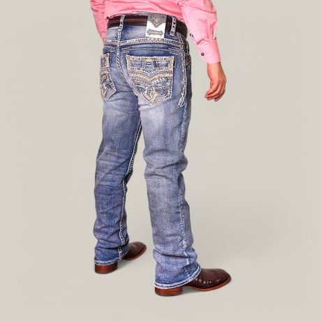 A person wearing Western Blue Straight Fit Embroidered Jeans WJ-2349, a pink long-sleeve shirt, and brown cowboy boots stands against a plain background.