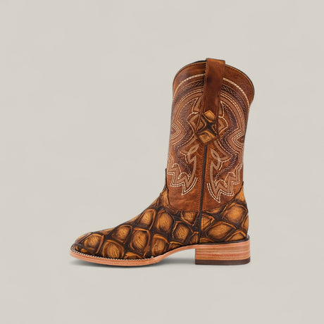 Big Bass Pirarucu Print Rustic Honey - Square Toe: A brown boot with a square toe, featuring an intricate stitched shaft and textured scale-like Pirarucu print on the foot, shown against a plain light background.