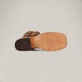 The Big Bass Pirarucu Print Rustic Honey - Square Toe boot features a brown design with a square toe, light tan leather sole with stitched details and subtle logo, plus a dark brown heel with visible nails for a classic Rustic Honey style.