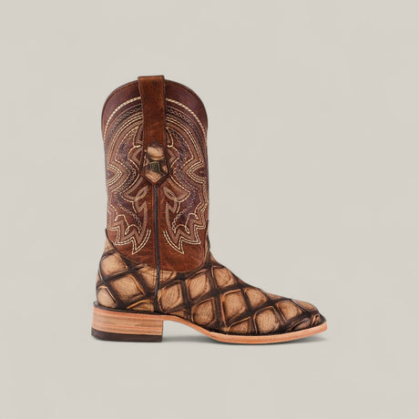 The Big Bass Pirarucu Print Rustic Camel - Square Toe is a single brown cowboy boot with intricate tan stitching on the upper shaft, a large diamond-patterned texture on the lower part, and features a wooden heel against a neutral background.