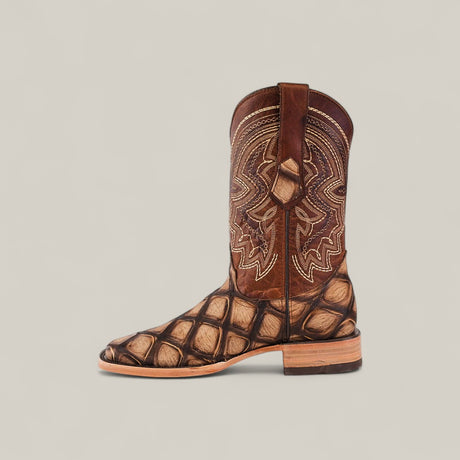 The Big Bass Pirarucu Print Rustic Camel - Square Toe is a brown leather cowboy boot featuring tan and gold stitching on the shaft and a textured, scale-like foot and heel, displayed against a plain light background.