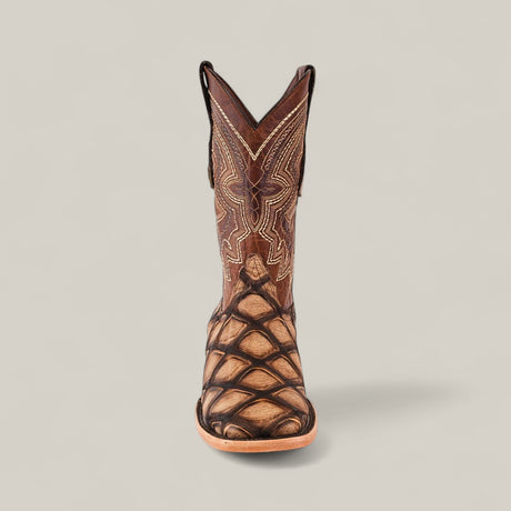 The Big Bass Pirarucu Print Rustic Camel - Square Toe is a single brown cowboy boot with intricate stitching and a distinctive textured pattern on the foot, displayed upright on a plain light background.
