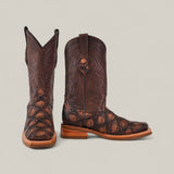 A pair of Big Bass Pirarucu Print Rustic Brown - Rodeo Toe boots, crafted from dark leather with lighter brown accents, are displayed on a plain light background—one facing forward, the other turned to the right.
