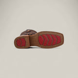 The Big Bass Pirarucu Print Rustic Brown - Rodeo Toe boot is shown from the bottom, highlighting its textured sole with red chevron treads and a red circular heel grip against a plain light background—ideal for Rodeo Toe fans.