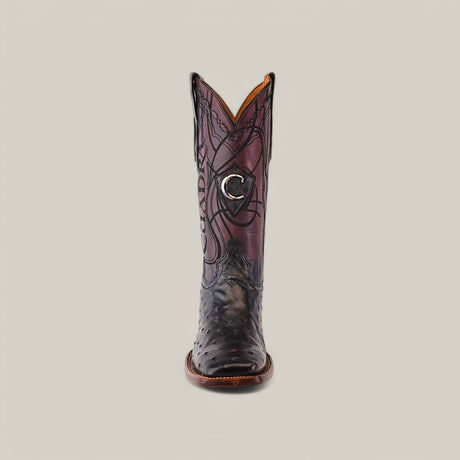 Front view of a single Blackcherry Ostrich CU786 boot with intricate laser-engraved details and crescent emblem on a reddish-tinted shaft, all set against a plain dark backdrop.