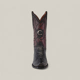 The Cuadra boot, Plunge Black Python Laser & Embroidery - Narrow Square Toe - CU607, showcases a textured black lower half like Python Leather Boots, a dark brown upper with detailed stitching and a laser-engraved silver emblem against a plain, light beige backdrop.