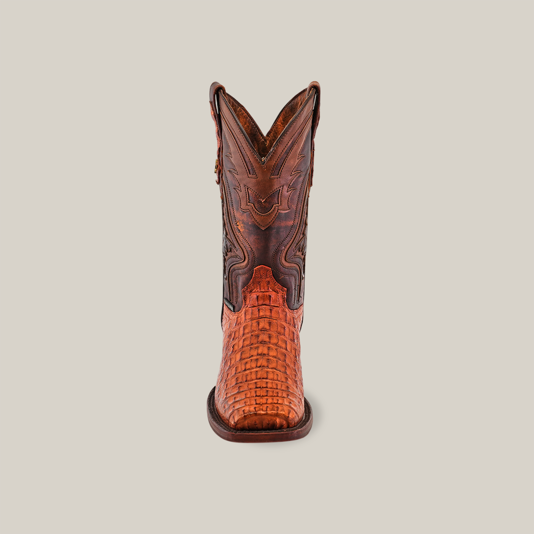 Front view of a single Exotic Caiman Hornback - Brandy - Rodeo Toe boot made from genuine caiman leather, showcasing intricate stitching and a woven texture on the foot part, set against a plain white background.