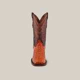 Front view of a single Exotic Caiman Hornback - Brandy - Rodeo Toe boot made from genuine caiman leather, showcasing intricate stitching and a woven texture on the foot part, set against a plain white background.