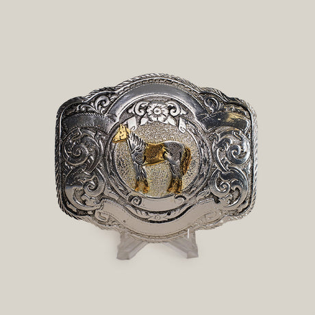 The Floral Full Horse Buckle is a decorative Texas-style buckle made from alpaca silver. It showcases an engraved gold horse at the center, surrounded by ornate western designs and floral motifs, making it a standout accessory.