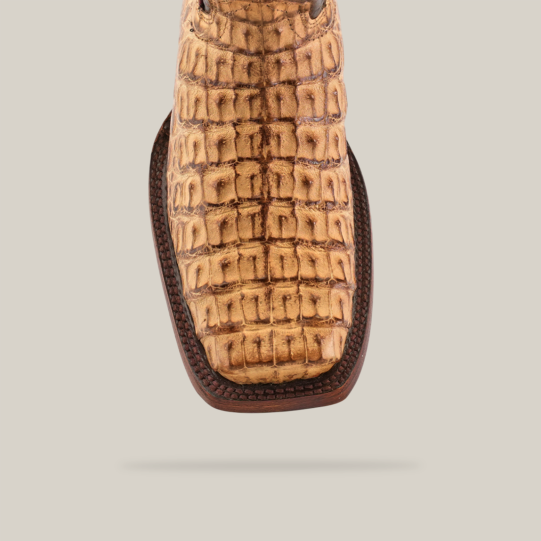 Close-up of an Exotic Caiman Hornback - Antique with a Rodeo Toe, showcasing authentic caiman leather with a crocodile texture and decorative stitching, on a plain white background.