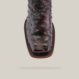 Close-up of an Exotic Ostrich - Black Cherry boot featuring a Rodeo toe, intricate red dot embellishments, and detailed stitching on black ostrich leather, set against a plain white background.