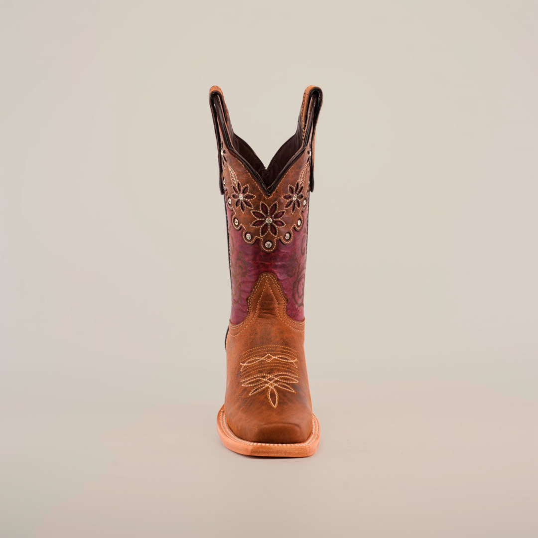 The Grecas Orix - Square Toe boot combines fashion and functionality with a premium leather design, brown lower, and purple embroidered upper adorned with floral patterns. This stylish boot features convenient pull straps, ideal for girls collections. Displayed on a white background.