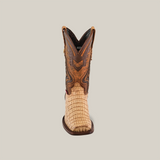The Exotic Caiman Hornback - Orix - Rodeo Toe is a single cowboy boot made from premium leather, showcasing a light tan, textured lower and a darker brown, intricate design on the upper shaft against a plain white background.