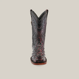 The Exotic Ostrich - Black Cherry cowboy boot boasts a genuine ostrich leather construction with intricate stitching and red accents. Displayed against a white background, it highlights its craftsmanship and unique rodeo toe design.