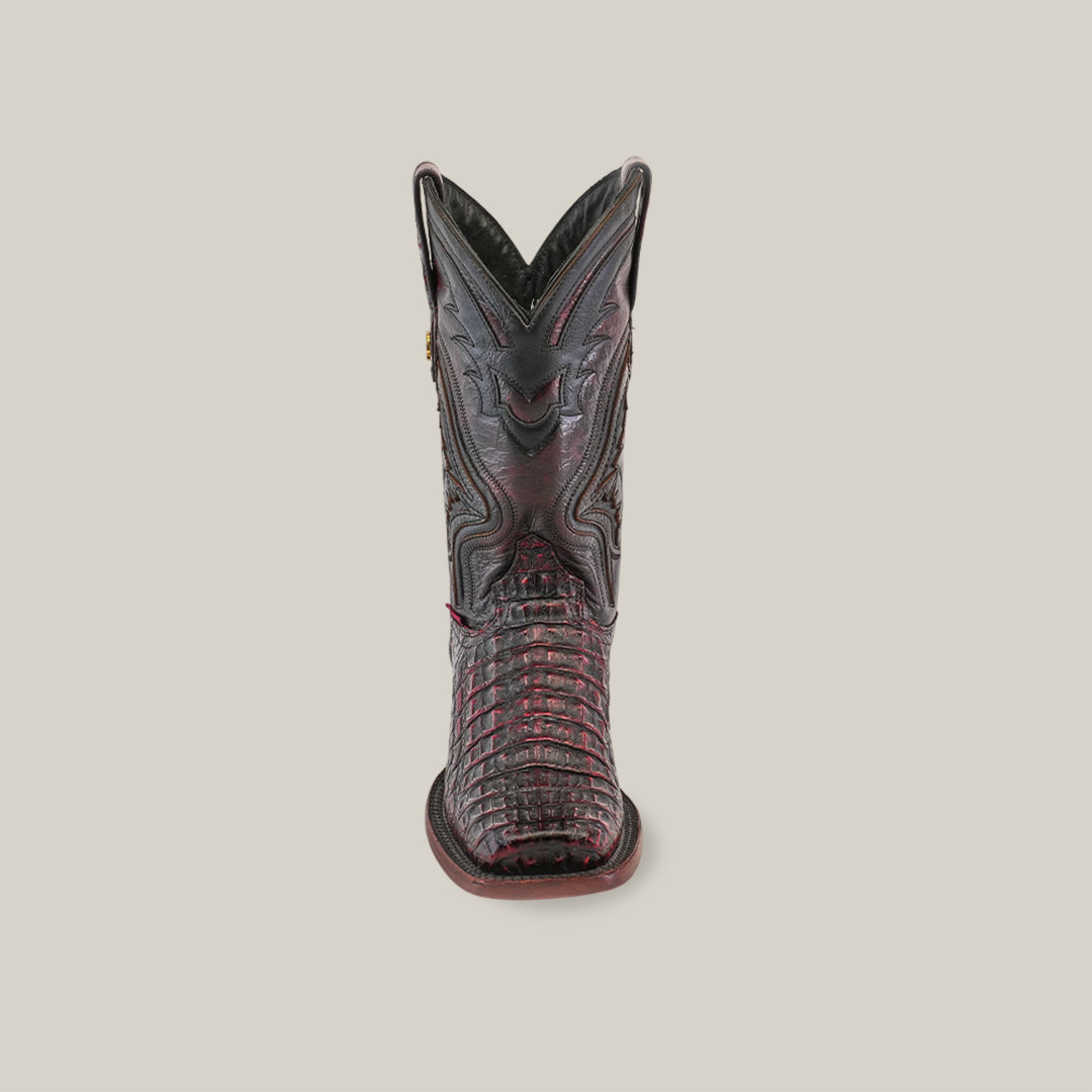 The front view of the Exotic Caiman Hornback boot in Black Cherry, showcasing its rodeo toe and intricate stitching against a plain white background, highlights craftsmanship meeting tradition.