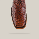 The Exotic Ostrich - Brown - Rodeo Toe shoe features a detailed ostrich skin texture, square toe design, and visible sole stitching that highlights its superior craftsmanship akin to classic cowboy boots.