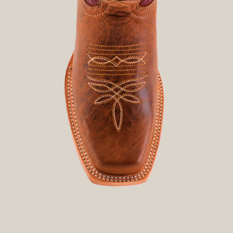 The Grecas Orix - Square Toe is displayed from the top view, showcasing its premium brown leather, intricate embroidery, square toe, and visible stitching along the soles edge. Its a fashionable choice for girls boot style enthusiasts on a plain white background.