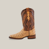 The Exotic Caiman Hornback - Orix - Rodeo Toe is a single cowboy boot made from premium leather featuring a light tan lower with textured design, darker brown intricate stitching on the upper, a decorative pull strap, and a low stacked heel in handcrafted quality.